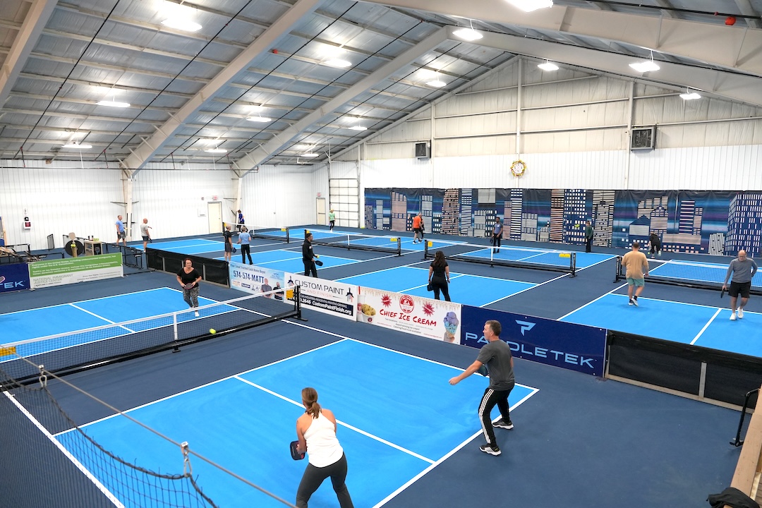 pickleball players playing a game inside a sports complex