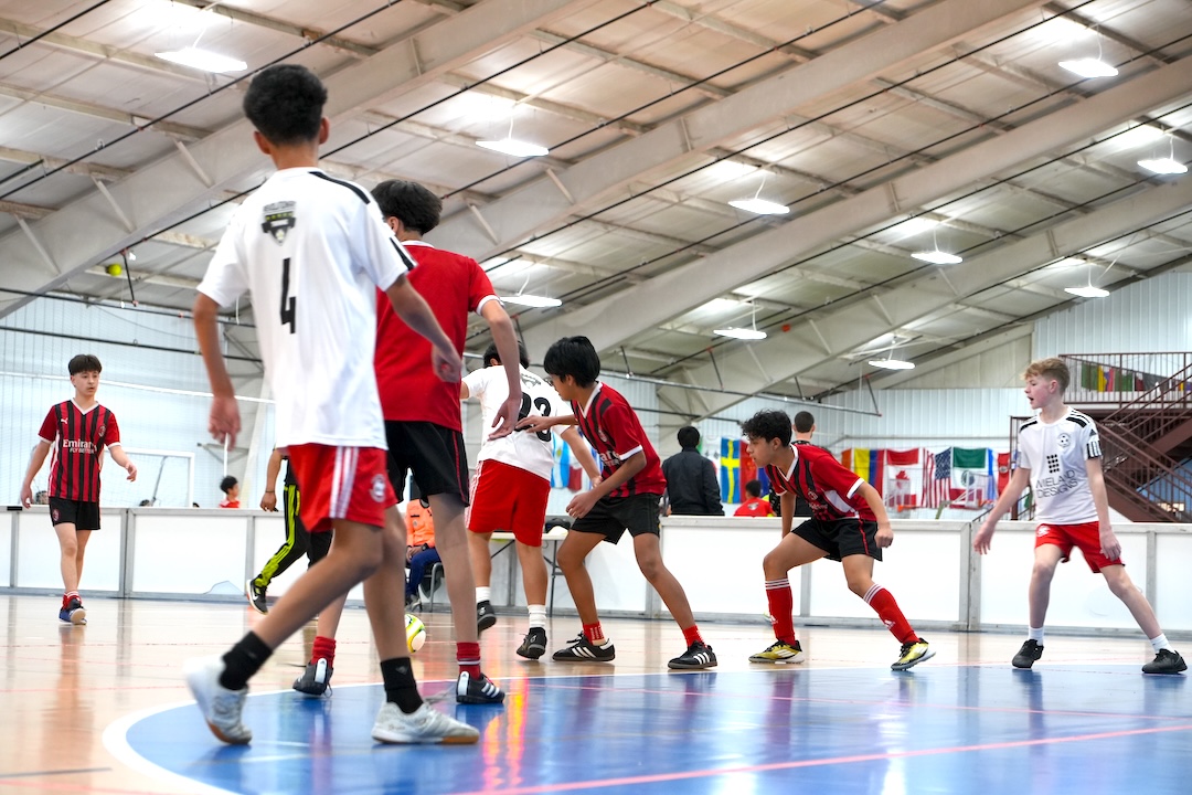 youth soccer players playing a competitive game of soccer inside goshen soccer academy
