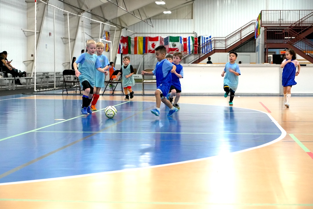 youth-soccer-in-goshen-indiana youth soccer players playing a game inside goshen soccer academy in goshen indiana
